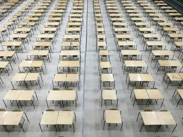 Rows of empty exam tables in a large room