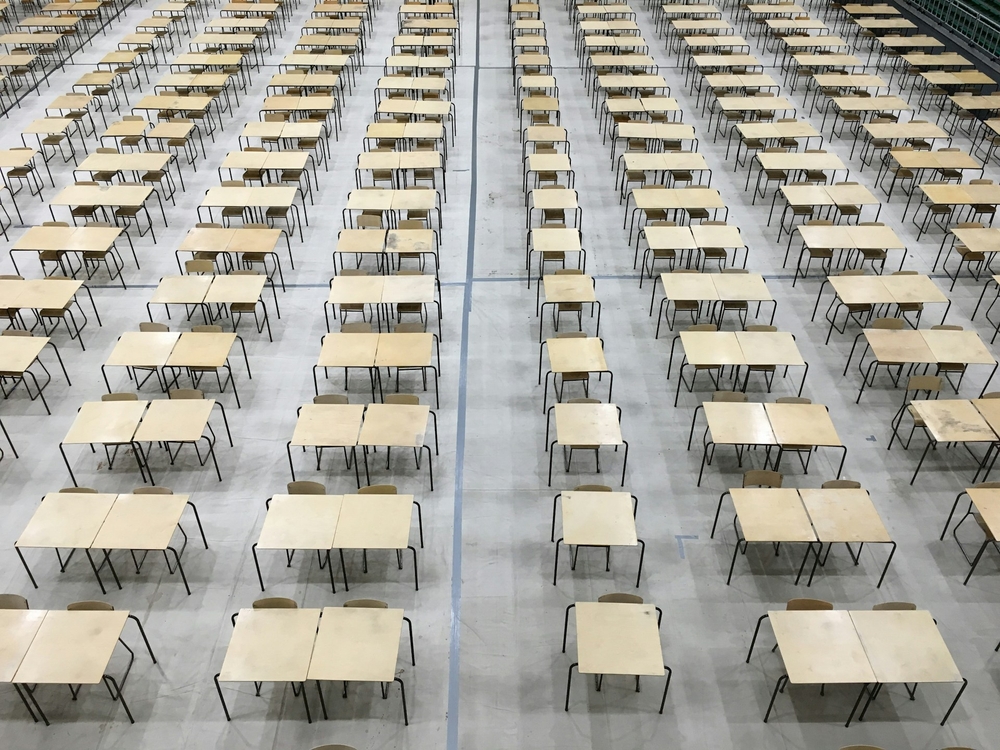 Rows of empty exam tables in a large room