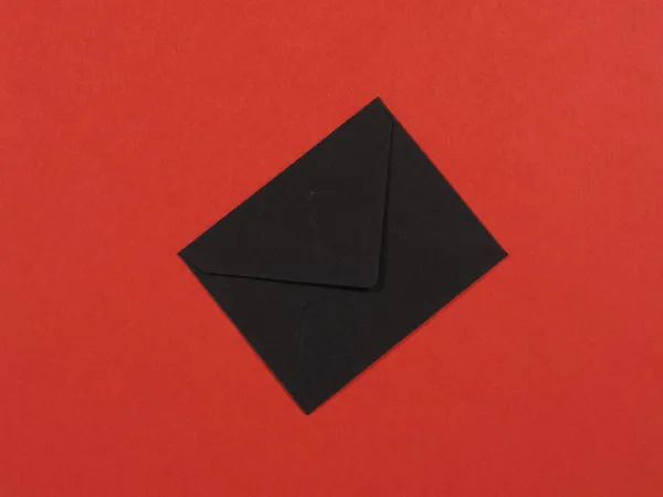 A Black Envelope on Red Background