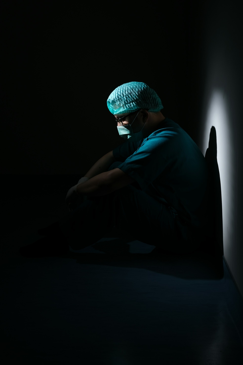 Healthcare worker looking down, depressed